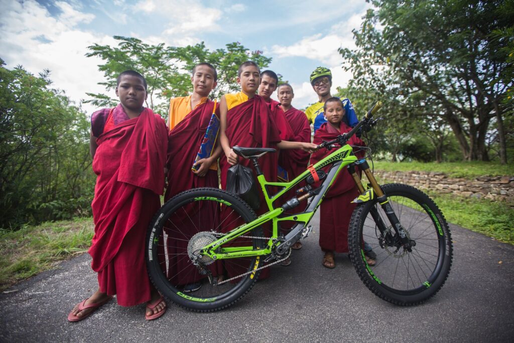 Young monks admire an enduro bike